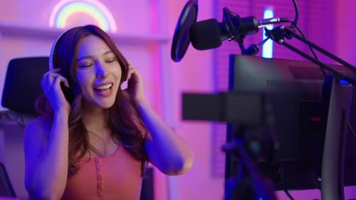 Smiling Woman Recording Podcast in Colorful Modern Studio