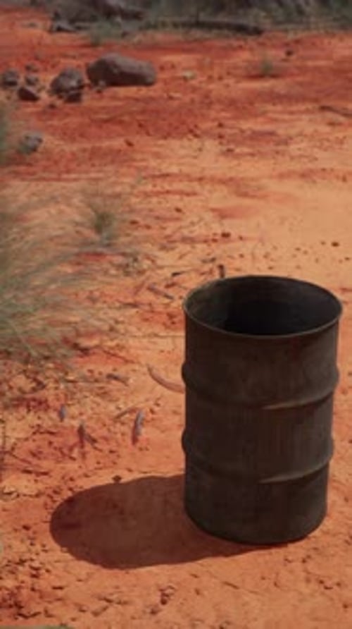 Old Empty Rusted Barrel on Sand