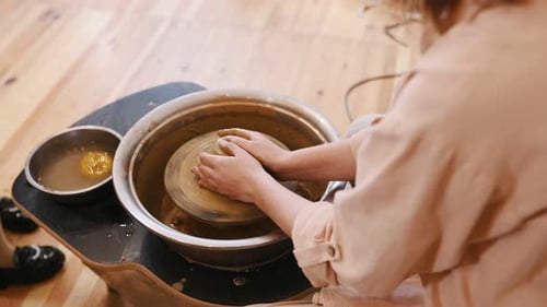 Adult and Child Enjoy Pottery Class Together