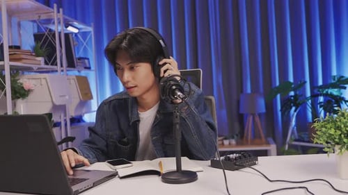 Young Asian livestream host starting live session in creative podcast studio