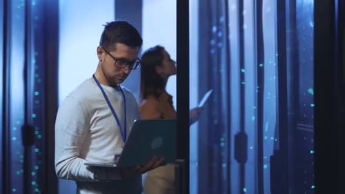 Engineers working in data center with server racks