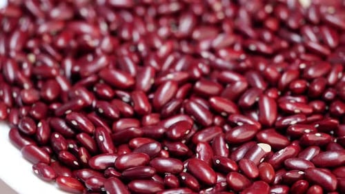 A close up of red beans and a pile of red beans