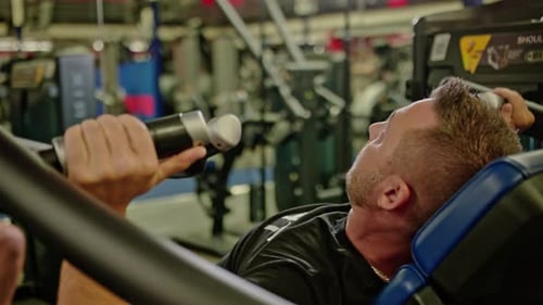 Strong Man Bench Pressing Weights in Gym