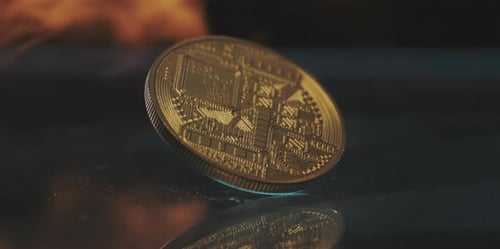 Bitcoin Coin with flames on reflective surface