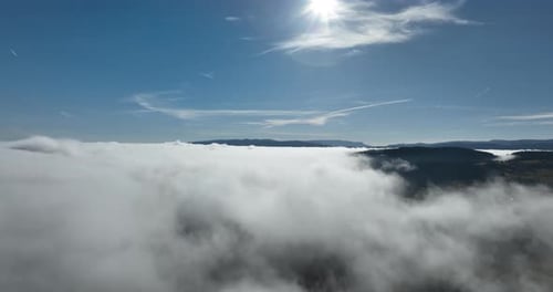 Drone Flight Over the Clouds During Sunrise