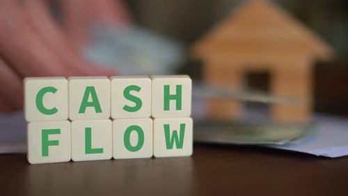 Cash Flow Blocks with Wooden House and Money