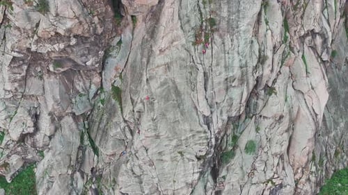 Climbers Ascending Steep Rock Face in the Mountains