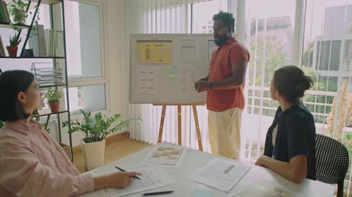 Multiracial Male Teacher Giving Presentation to Students