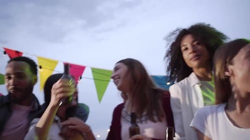 Group of Multiracial Friends in a Terrace Dancing and Having Fun Together