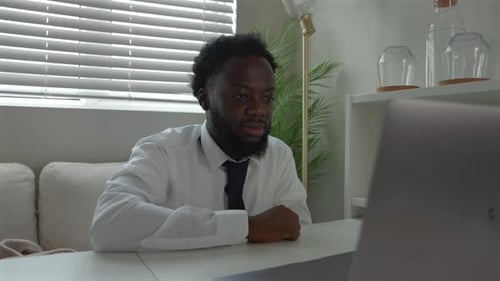 Cheerful Black Male Remote Worker On A Video Call In Home Office