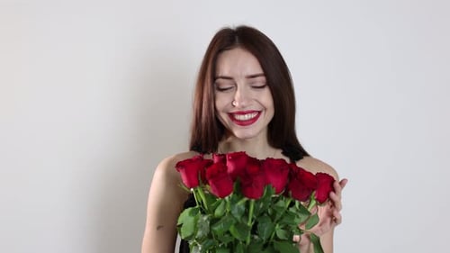 St. Valentine's Day. Beautiful woman with bouquet of roses on white background