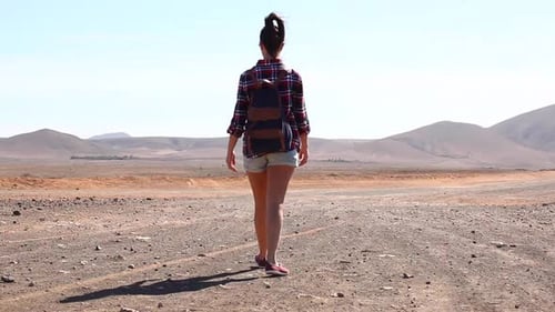 Happy woman walking in the desert in Fuerteventura