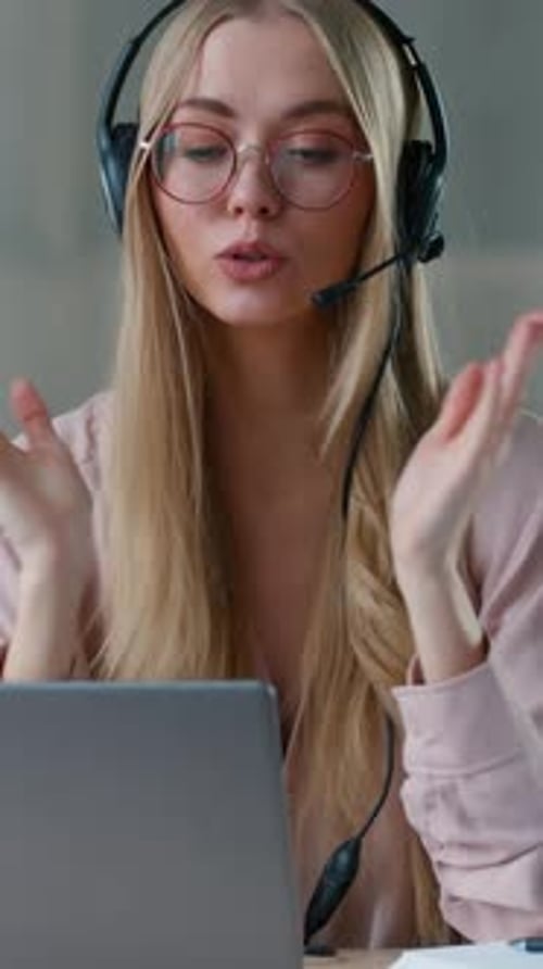 Young Woman Using Laptop and Headset for Video Call