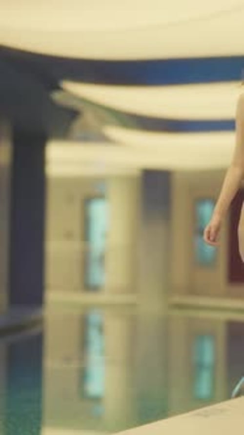 Woman with Reddish-Brown Hair Posing in Swimsuit