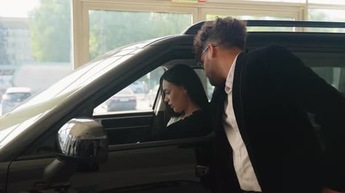 Woman and Man in Car in Dealership