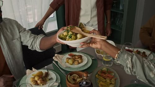 Friends Gather Around Dinner Table Serving Food