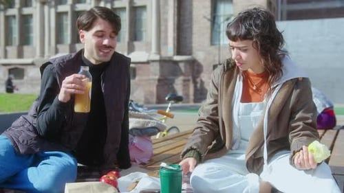 College Friends Having Snacks with Drinks and Talking Outdoors on Campus