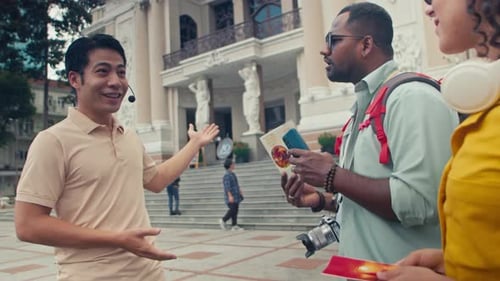 Asian Guide Conducting Sightseeing Tour for Diverse Newlywed Couple