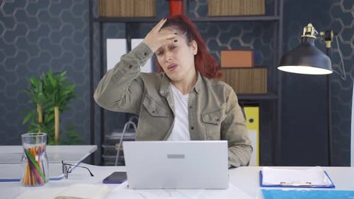 Business woman suffering from migraine.