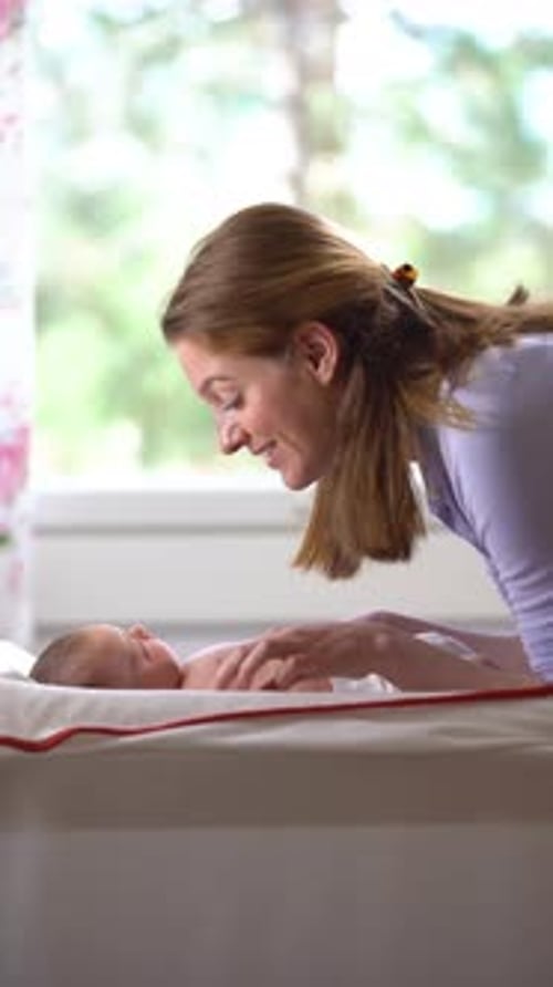 Loving Mom Playing with Her Baby at Home