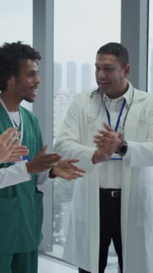 Hospital Workers Clapping Hands in Hall Vertical