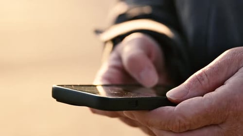 Adult Fingers Swiping Smartphone in Close Up