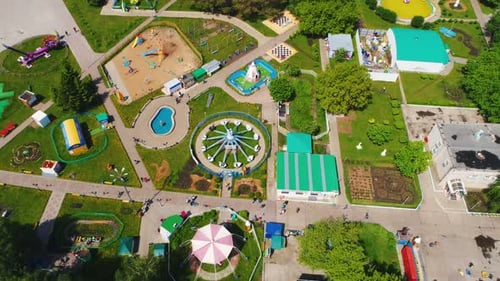Attractions and Playground in Park Against City