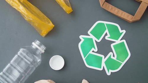 Recycling, Garbage Disposal And Ecology Concept - Green Recycle Symbol With Household Waste On Gr...
