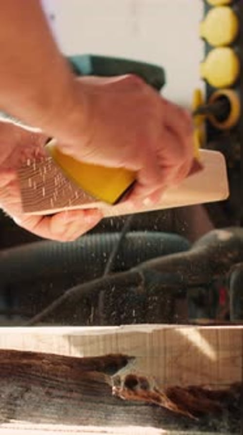 Craftsman Smoothing Wood in Workshop