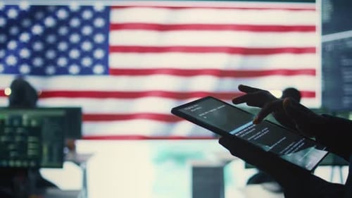 Person using Tablet in Coding Office with Flag