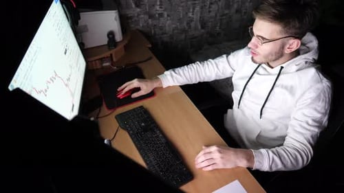 Frustrated Young Adult Working Late at Computer