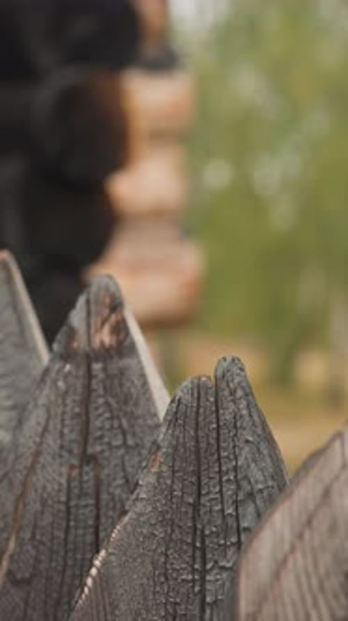 Rustic Wooden Fence Tracking Shot with Cabin Backdrop