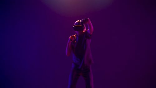 Skilled Man Playing Immersive Virtual Reality Game Alone. Vr Goggles Guy Gaming Fighting Using Co...
