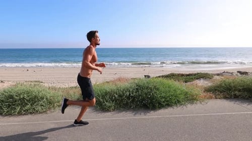 Athletic Man Exercising At The Beach