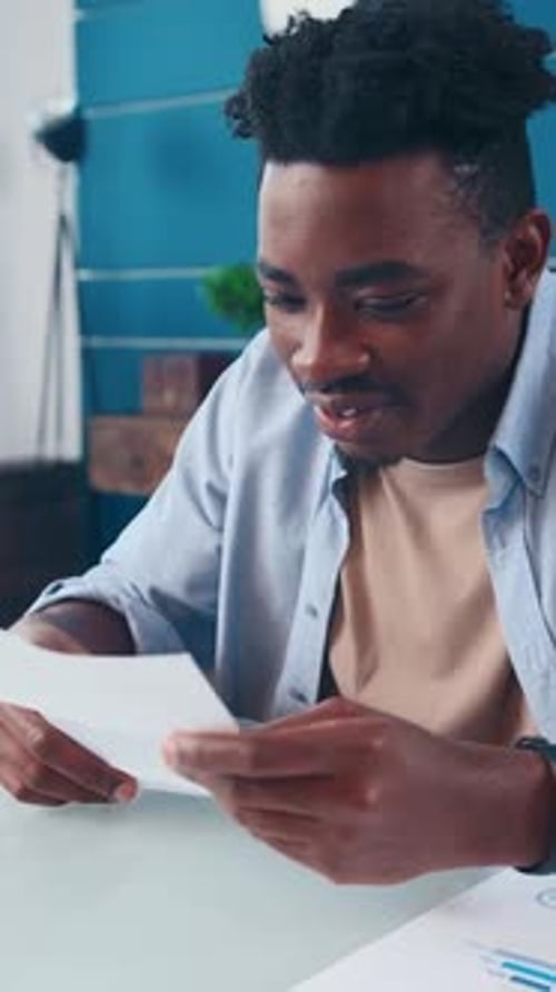 Young Adult Celebrating Success Reading Good News