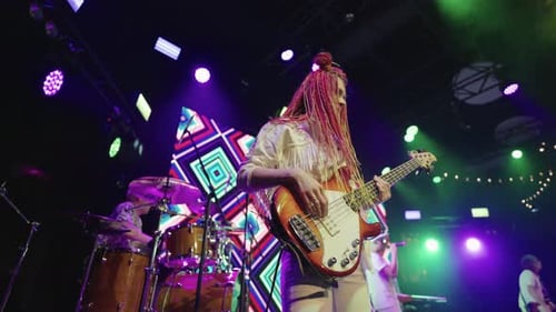 Female Bassist Performing with Energy at Concert