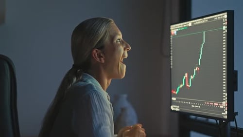Euphoric Blonde Female Trader Celebrates Big Green Candle on Trading Chart