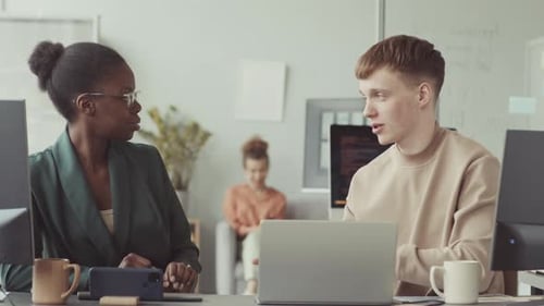 Diverse Programmers Chatting at Workplace