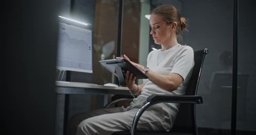 Woman Analyzing Data at Computer in Modern Office