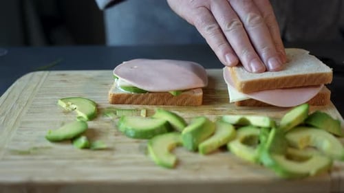 Preparing Healthy Sandwiches with Avocado on Cutting Board