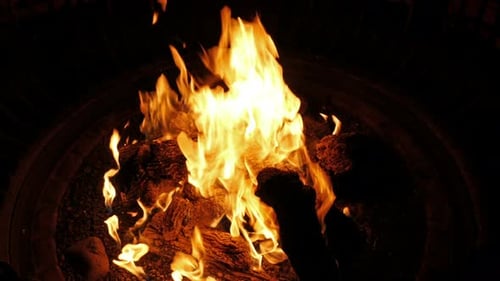 Roaring Bonfire Flames in Dark Pit at Night