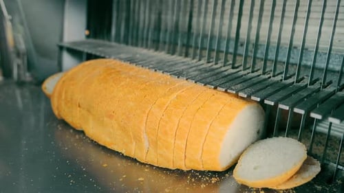 Fresh Loaf on Conveyor Belt A Fresh Loaf of Bread on the Conveyor Belt of a Bakery