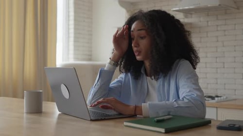 Frustrated Woman Working on Laptop at Home
