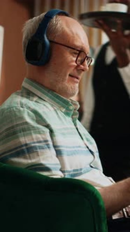 Man With Headphones Relaxing in Armchair