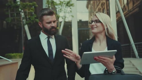 Group of Professionals Collaboratively Planning Using Tablets in Outdoor Office Environment with