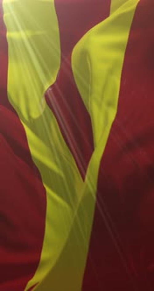 Waving Red and Yellow Striped Flag with Light Rays