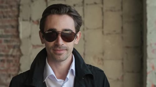 Fashion Young Man Holding His Fashionable Sunglasses