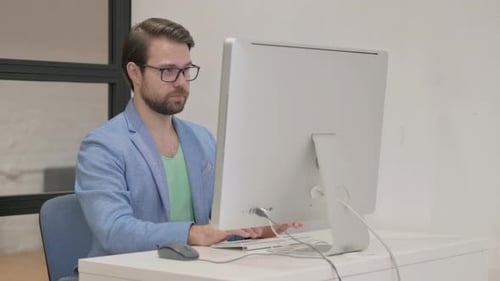 Young Man Looking at Camera in Office