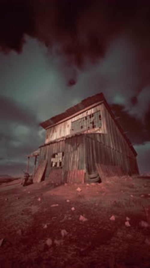 Old Wooden Building Atop Dry Grass Field