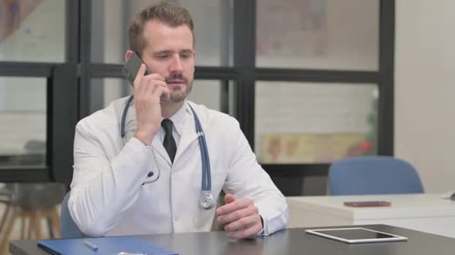 Doctor Talking on Phone in Office Setting
